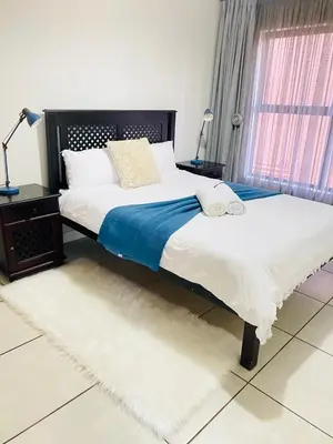 a bedroom with two beds and a window at The Blyde SUPER STAR in Pretoria