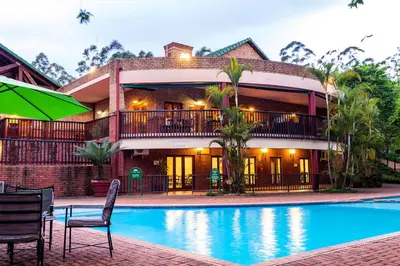 a house with a swimming pool in front of a building at Peace and Comfort - Greenway Woods in White River