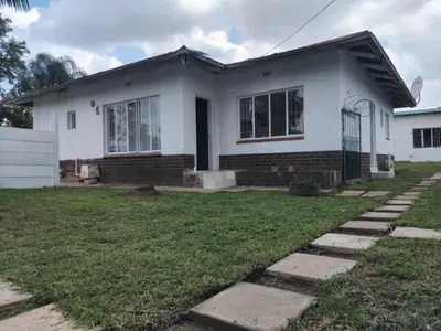 a white house with a lawn in front of it at Claremont Secured Residence in Pretoria