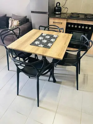 a wooden table and chairs in a kitchen at Calm & Cozy Apartment 2 in Pretoria