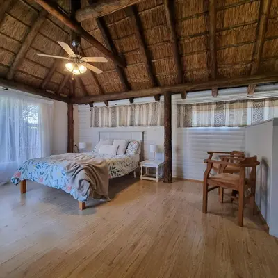 a bedroom with a bed and a ceiling fan at Kruin cottage in Pretoria