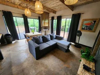 a living room with a couch and a table at Hartbeest Bush Stay #26 in Kosmos