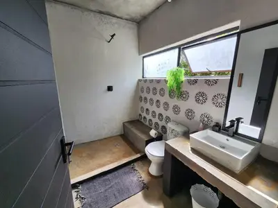 a bathroom with a white toilet and a sink at Hartbeest Bush Stay #28 in Hartbeespoort