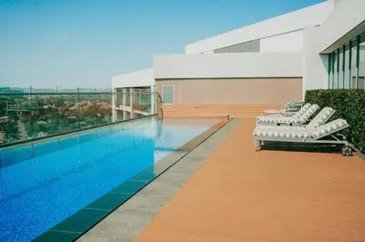 a swimming pool with lounge chairs next to a building at Menlyn Maine Trilogy 1417 in Pretoria