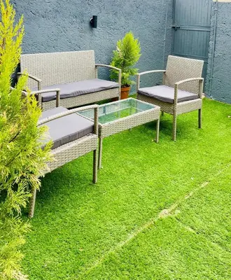 three chairs and a glass table in a yard at 13 Orion Aparment in Polokwane