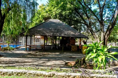 a pavilion in a park with a bench and trees at Phabema Guest House in Steelpoort