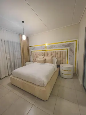 a bedroom with a large white bed in a room at THE BLYDE CRYSTAL LAGOON F&S LUxurious Apartment 3bed in Pretoria