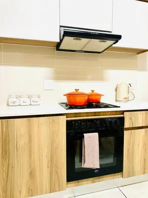 a kitchen with a stove with two pots on it at Beach-Style Bliss at The Blyde in Pretoria