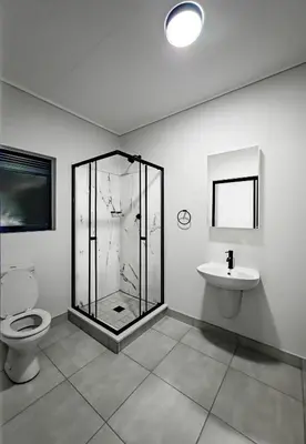 a bathroom with a shower and a toilet and a sink at The Blyde 3bed Beach Facing F&S Luxurious 2 in Pretoria