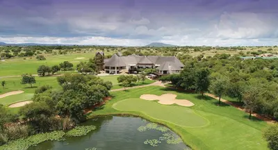 an aerial view of a golf course with a house at Zebula 1 Pela Lodge, 6 bedrooms in Warmbaths