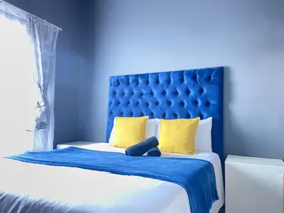 a blue bed with a teddy bear sitting on it at A spacious 2bedrooms apartment in the heart of Kempton Park in Kempton Park