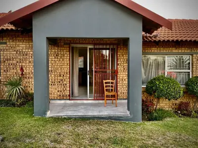 a chair sitting on the front porch of a house at Little Swift 1 in Secunda