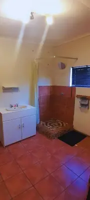 a bathroom with a tub and a sink in a room at Cozy in Centurion