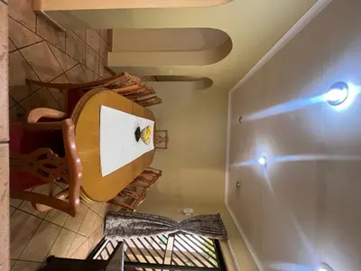 a room with a spiral staircase in a house at Bugera's Palace in Pretoria