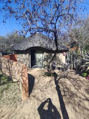 a house with a shadow of a tree at Aloe Bush Game Lodge in Marble Hall