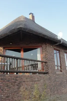 a window of a brick building with a balcony at Mabula Game Reserve in Welbekend