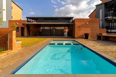 a swimming pool in the backyard of a house at The Local house in Midrand