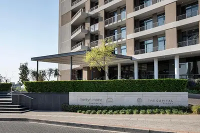 a building with a sign in front of it at Menlyn Maine Trilogy Apartment in Pretoria