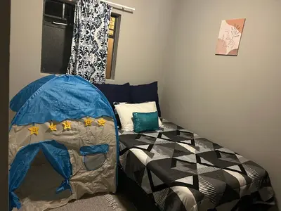 a bedroom with a bed with a tent in it at Peaceful Cute Apartment in Pretoria