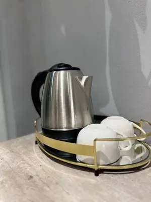 a tea kettle on a tray next to two mouses at Glowti Event & Guest House in Centurion
