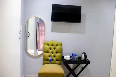 a yellow chair in a room with a mirror at Glowti Event & Guest House in Centurion