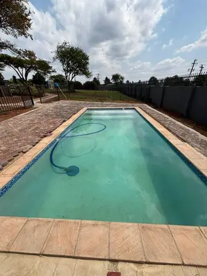 a swimming pool with a hose in the water at Glowti Event & Guest House in Centurion