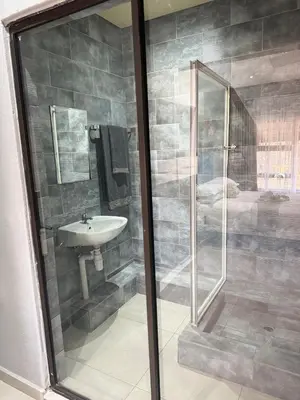 a bathroom with a shower and a sink at Glow Events &Guest House in Centurion
