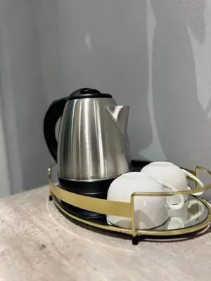 a tea kettle on a tray next to two mouses at Glow Events & Guest House in Centurion