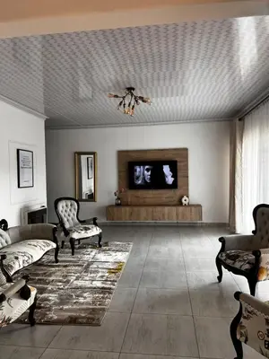 a living room with a couch and a flat screen tv at Luxury Airport Flatlet in Kempton Park