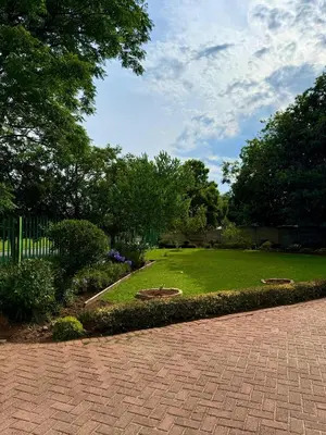 a garden with a brick walkway in a park at Meadway on the parks in Benoni