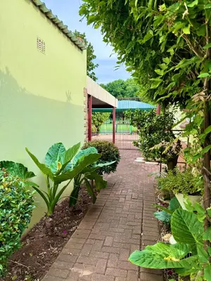 a brick walkway in a garden with plants at Cosy retreat for 2 at MeadWay in Benoni