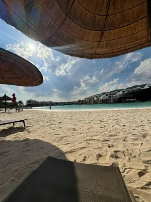 a view of a beach with an umbrella and the ocean at The Dream Stay At The Blyde - Suite 2 in Pretoria