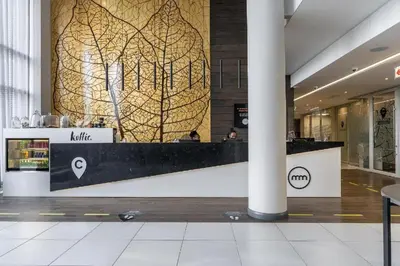 a lobby with a reception desk in a building at Chic Deluxe Studio, Menlyn Maine, Smart Access in Pretoria