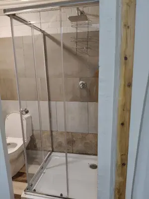 a shower stall in a bathroom with a toilet at The Man Cave Extension in Sabie