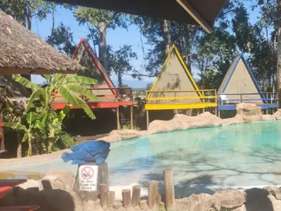 a pool at a resort with a water slide at Waterfall Cabana 3 - Beach Island in Graskop