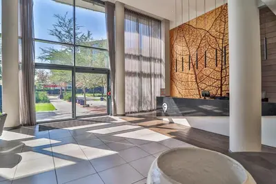 a lobby with a large window and a large tub at Menlyn Maine 1413 in Pretoria