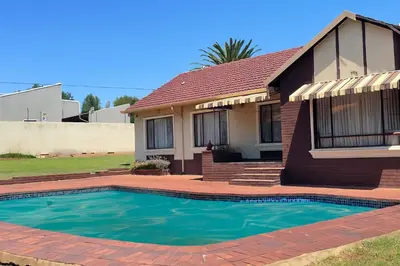 a house with a swimming pool in front of it at Inocova Fly in Kempton Park