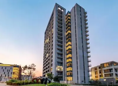 a tall building with lights on in a city at Menlyn Maine Trilogy Apartment 914A in Pretoria