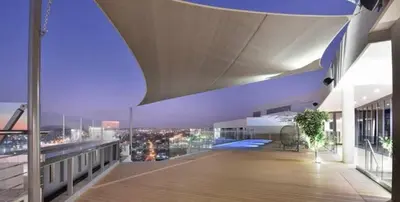 a balcony of a building with a view of a city at Menlyn Maine Trilogy Apartment 1220 & 1221 in Pretoria