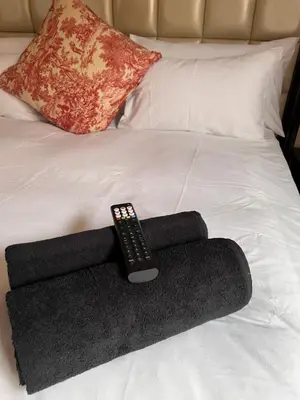 a remote control sitting on top of a bed at Morningmist Boutique 27 Room 3 in Centurion
