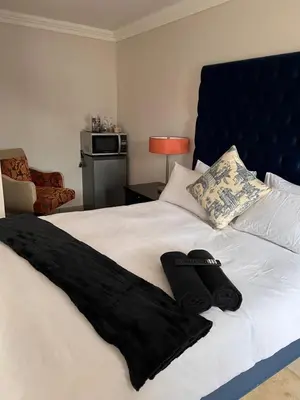a bedroom with a bed with black towels on it at MorningMist Boutique 27 Room 2 in Centurion