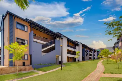 an image of an apartment building with a lawn at Home Away By Waterfall in Midrand