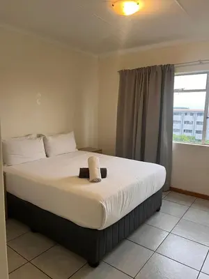 a large bed in a room with a window at Menlyn Place 506 in Pretoria