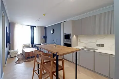 a kitchen with a table and chairs in a room at 1 Thango Executives Ellipse Gallileo in Midrand