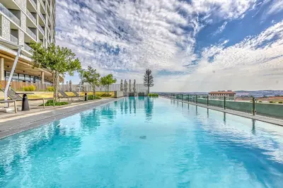 a large pool with blue water in a building at Belle Vue at Ellipse in Midrand