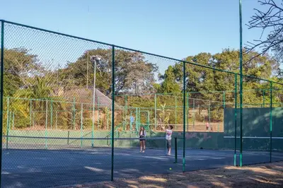 two children playing tennis on a tennis court at Kruger Park Lodge Unit No 440 in Hazyview