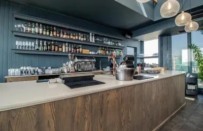 a kitchen with a bar with a counter top at Menlyn Maine Trilogy Apartment 1506 in Pretoria
