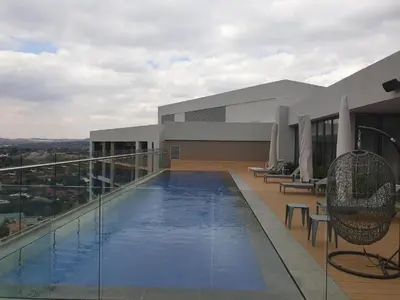 a swimming pool on the roof of a building at Menlyn Maine Trilogy Apartment 1506 in Pretoria