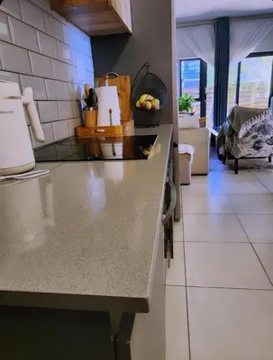 a kitchen with a counter top in a room at Cozy Corner in Midrand