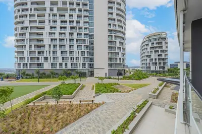 a large white building with two tall buildings at Skyline Serenity in Midrand